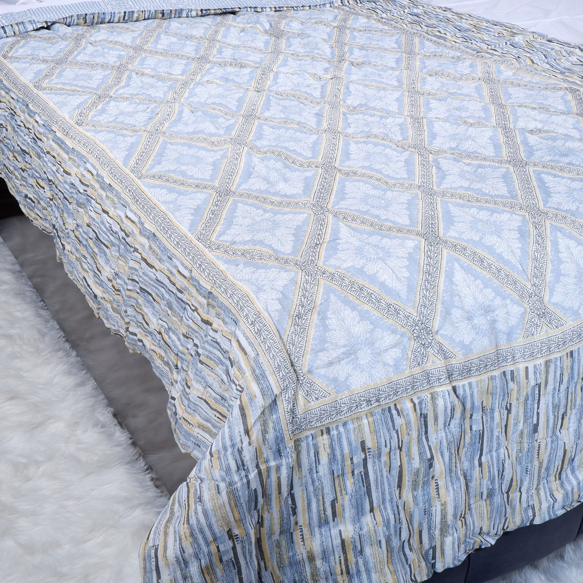 The Jaipuri 100% cotton single bed quilt with elegant blue patterns and intricate border design
