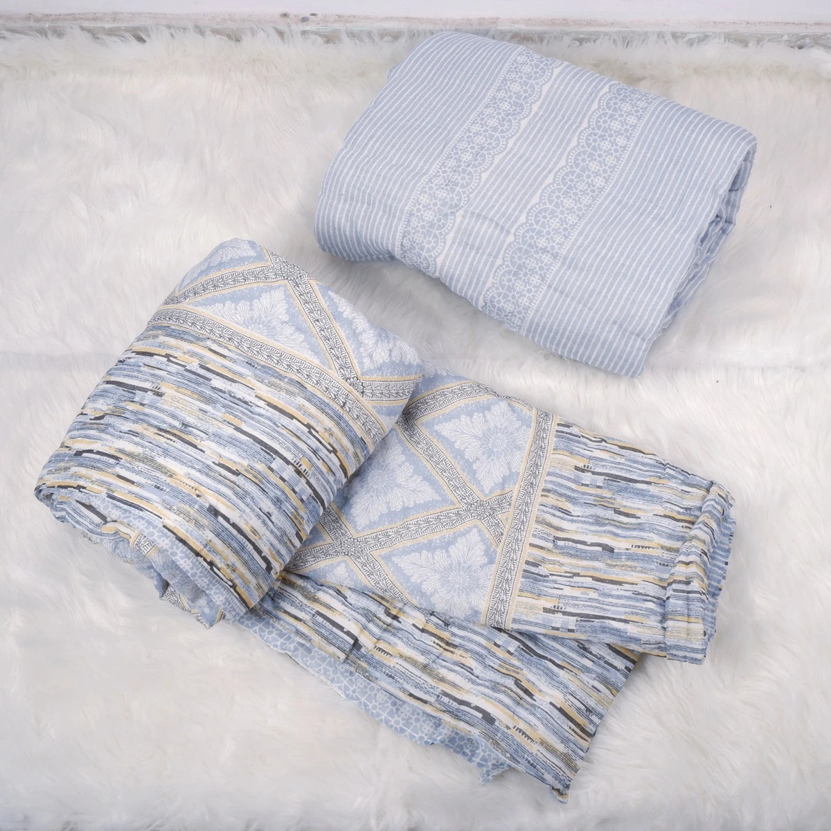 Two elegant quilts from The Jaipuri, featuring blue patterns, 100% cotton single bed quilt for stylish bedroom decor.