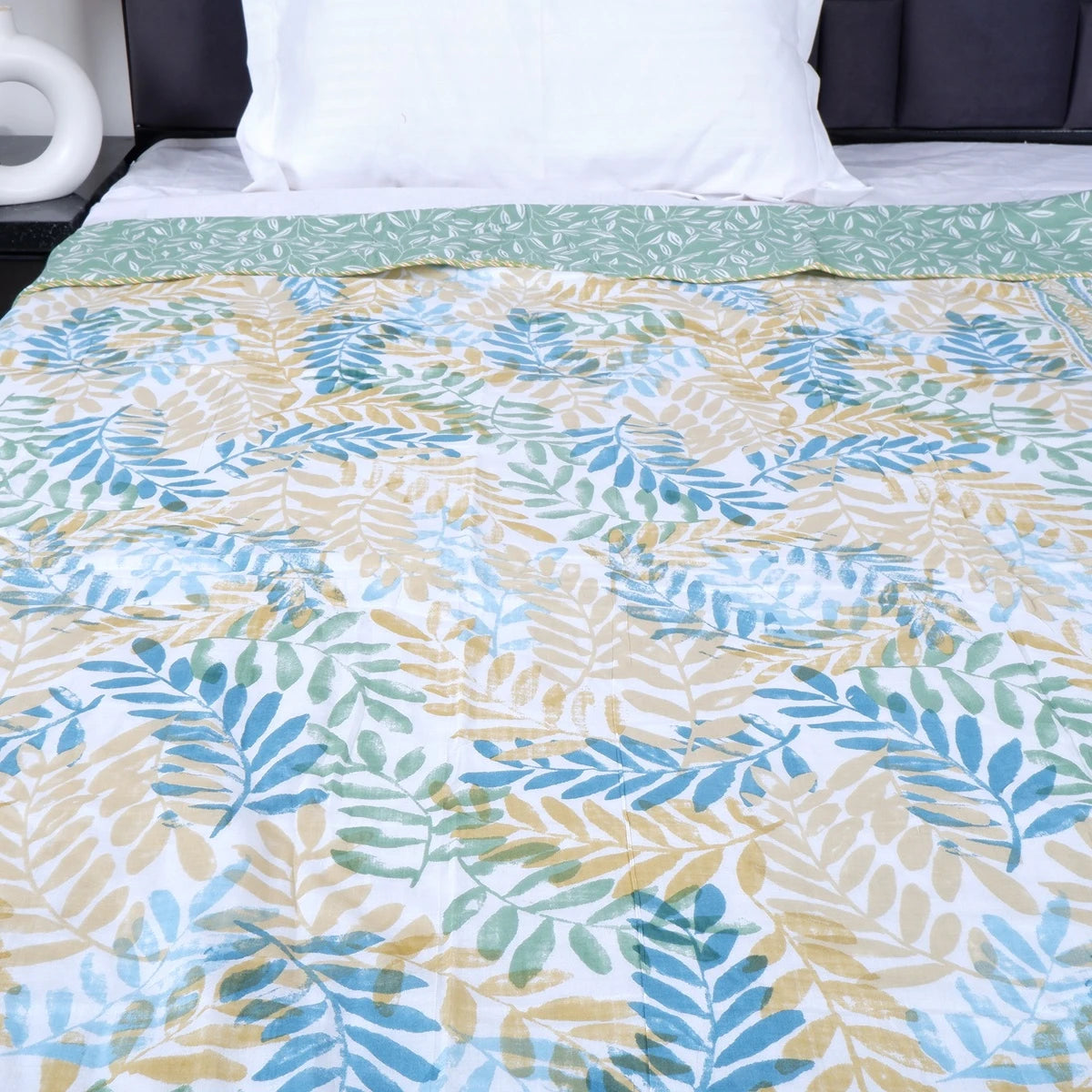 The Jaipuri 100 percent mulmul cotton blanket with a leafy design in soothing colors