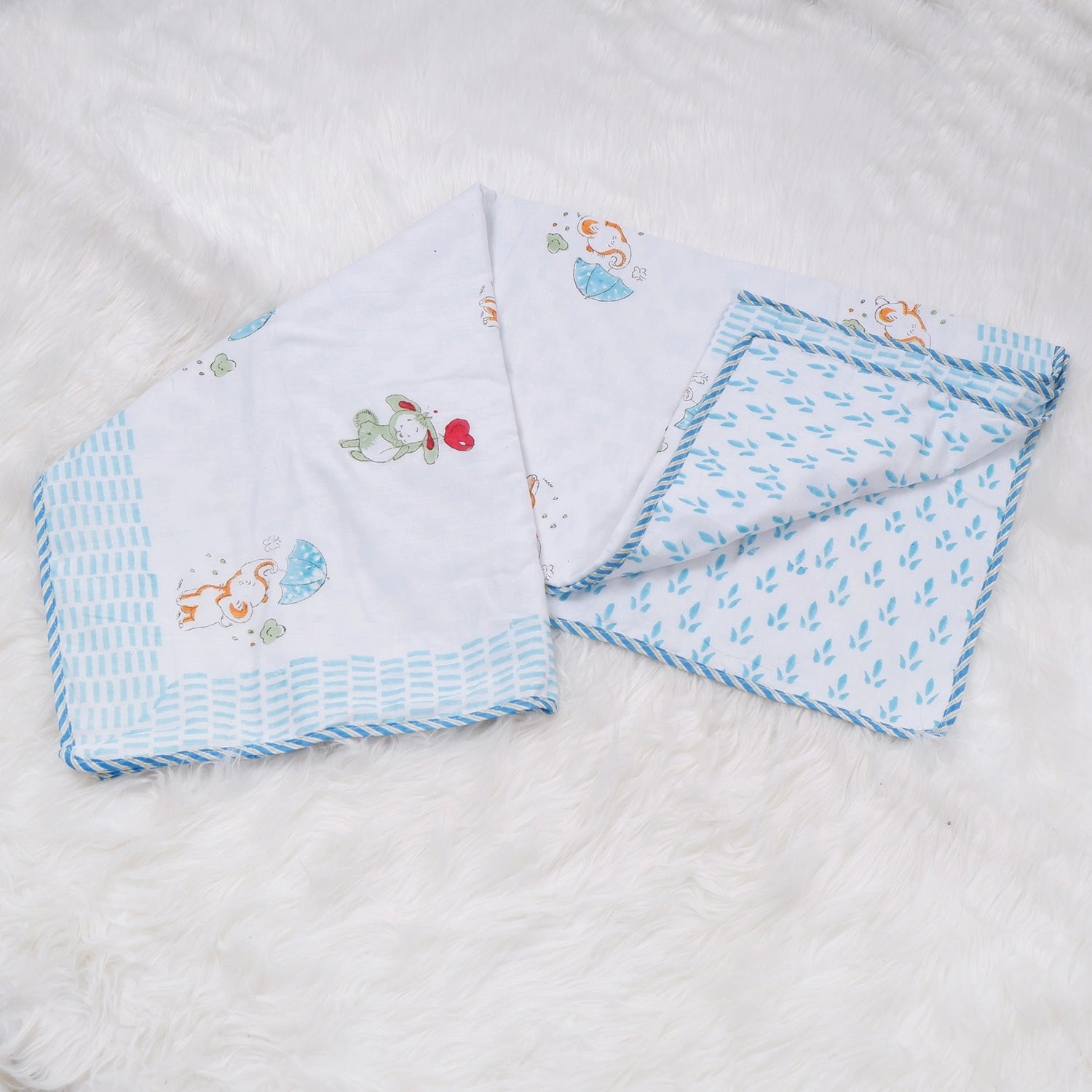 Hand block print kids dohar featuring playful animal designs in soft pastel colors