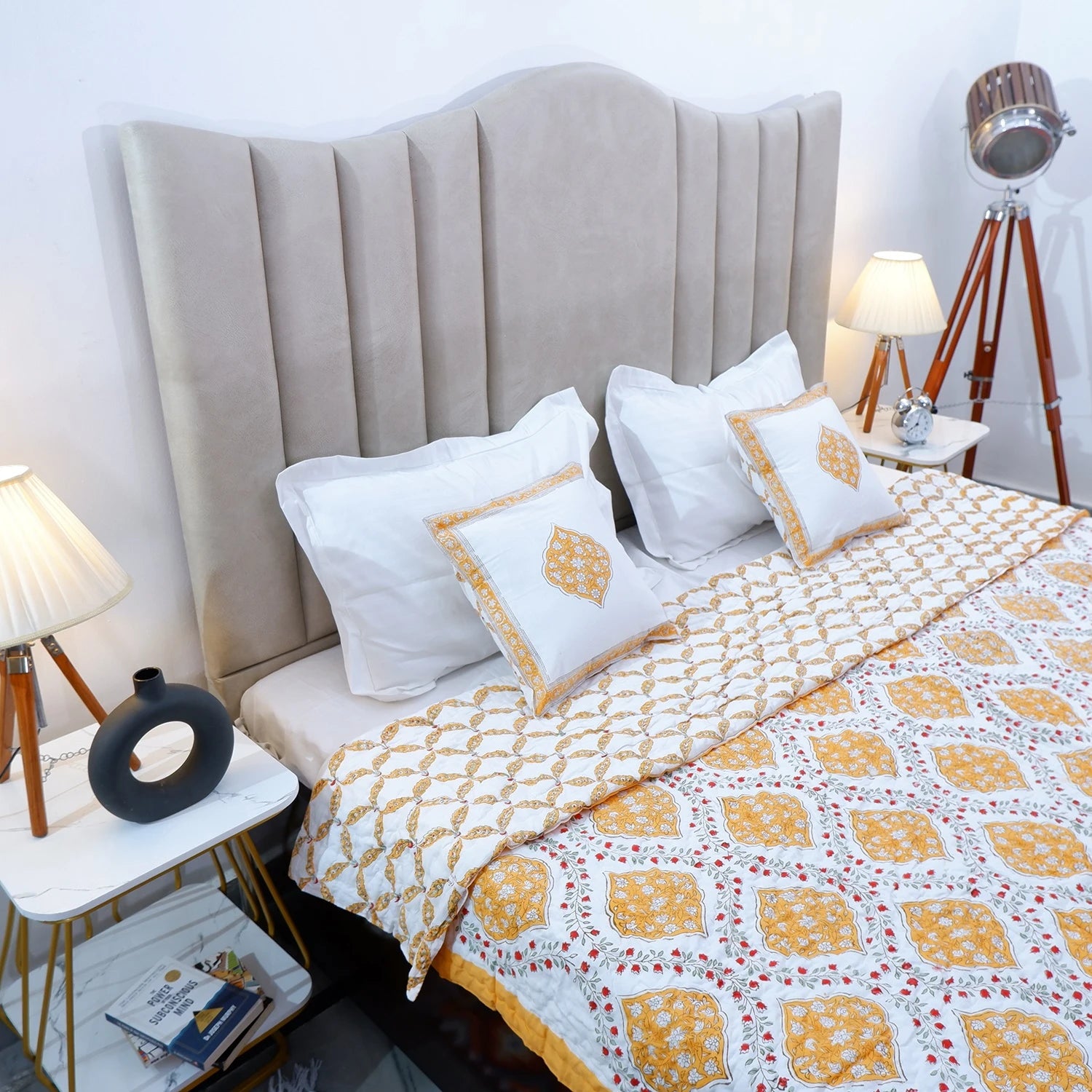 Block print cotton quilt for double bed in vibrant floral design, paired with matching pillows