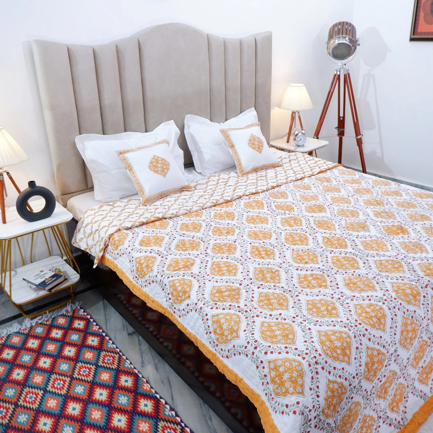 Jaipuri block print cotton quilt for double bed in yellow and white design on a stylish bed