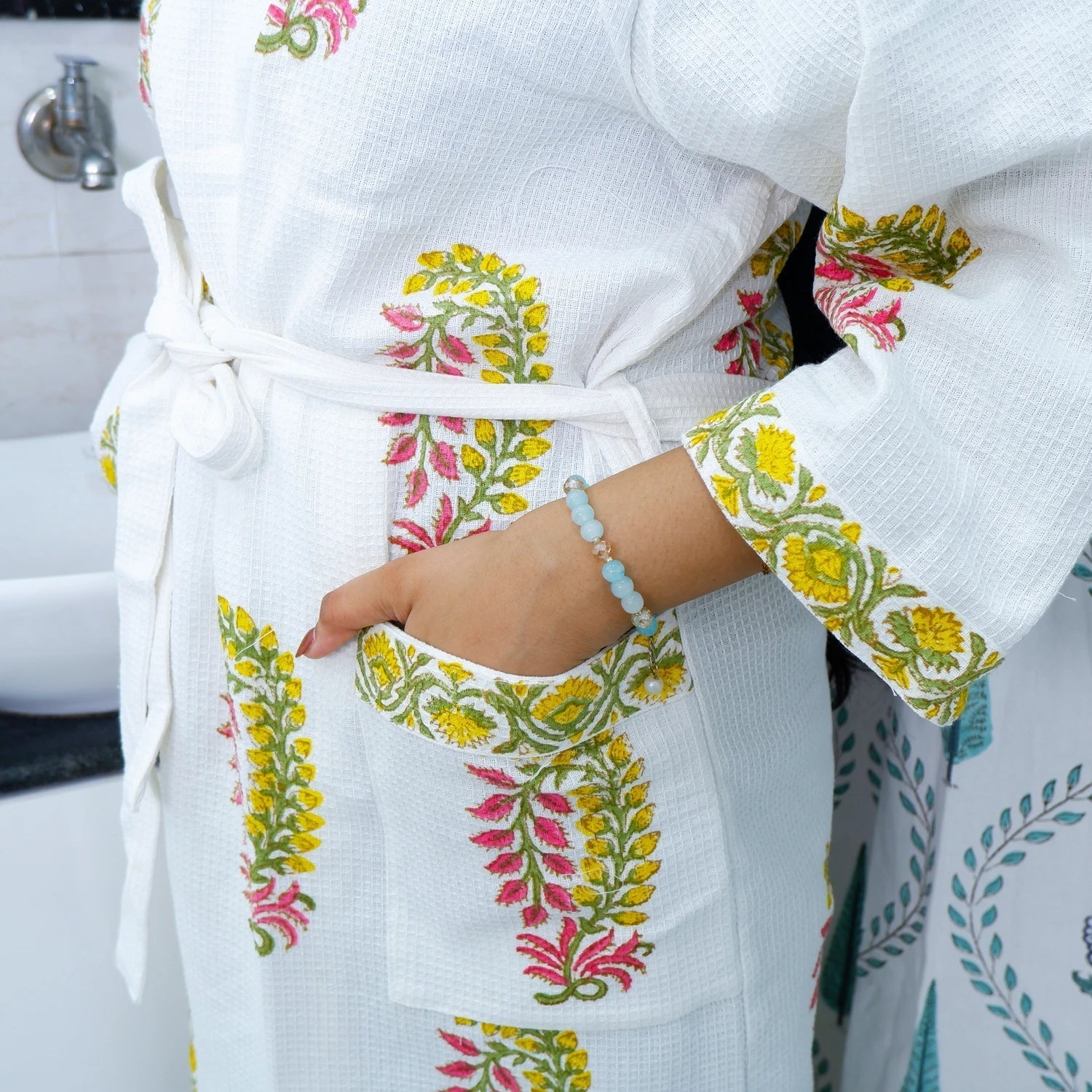 White cotton hand block printed bathrobe with colorful floral designs and pockets