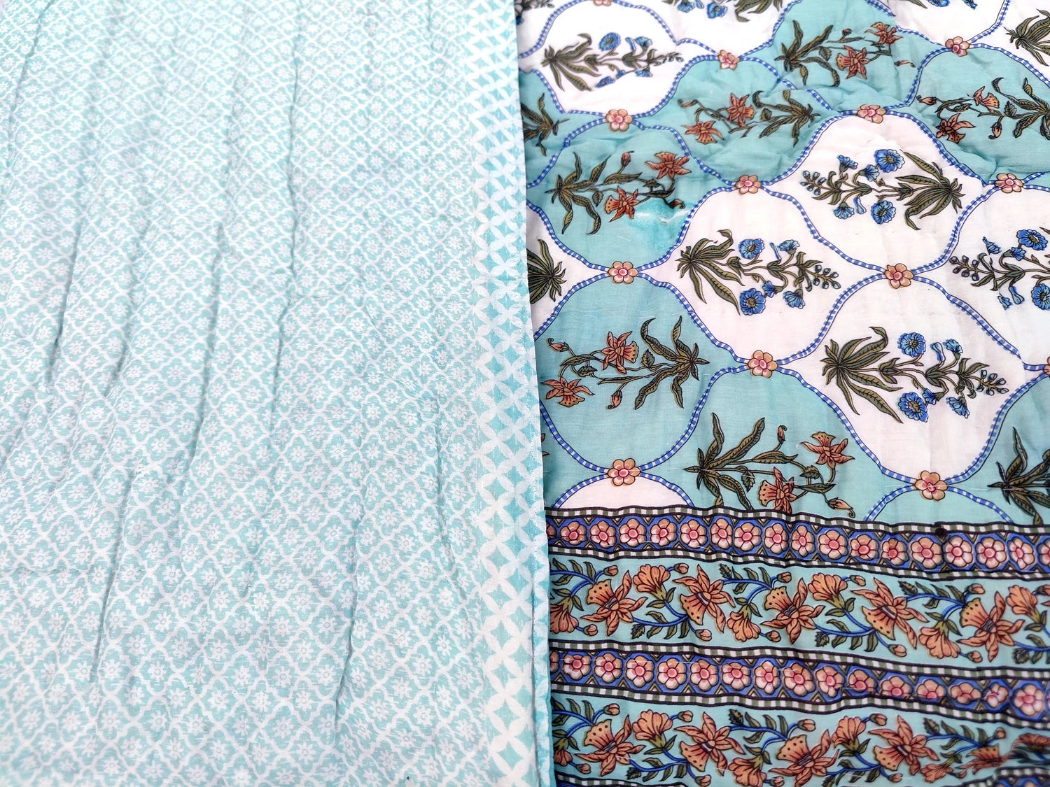 The Jaipuri cotton quilt for double bed block print featuring intricate floral designs in blue and white