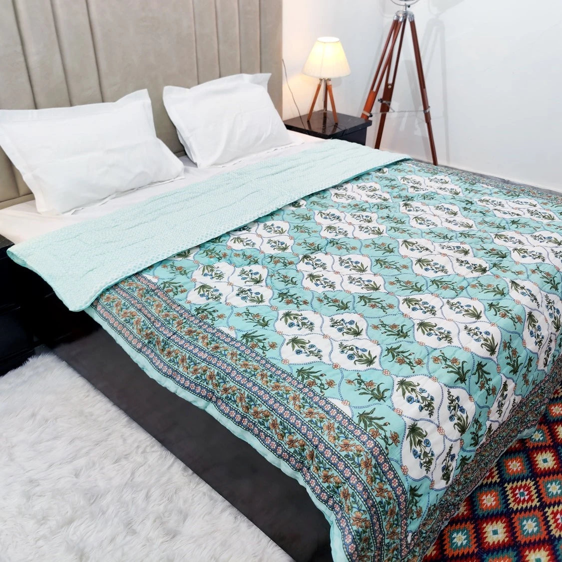 Beautiful cotton quilt for double bed block print with vibrant floral patterns on a cozy bedroom setting