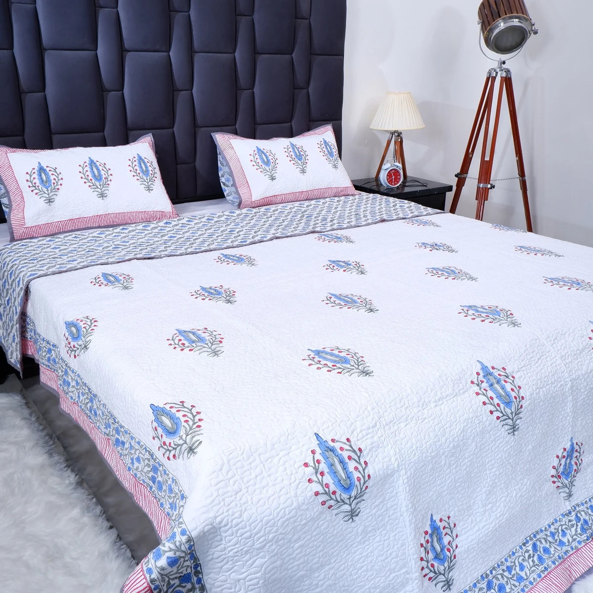 Hand block print cotton bedcover from The Jaipuri with intricate floral patterns and matching pillows