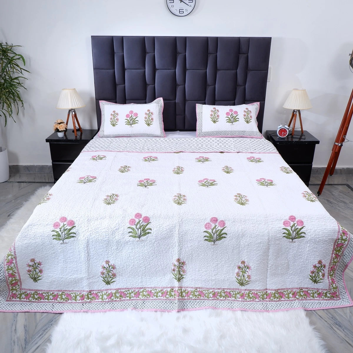 Hand block print cotton bedcover in white with intricate floral patterns and matching pillows