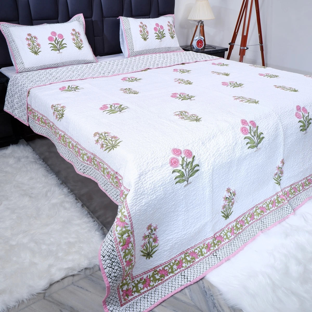 Hand block print cotton bedcover with floral design in soft pastel colors for elegant bedroom decor