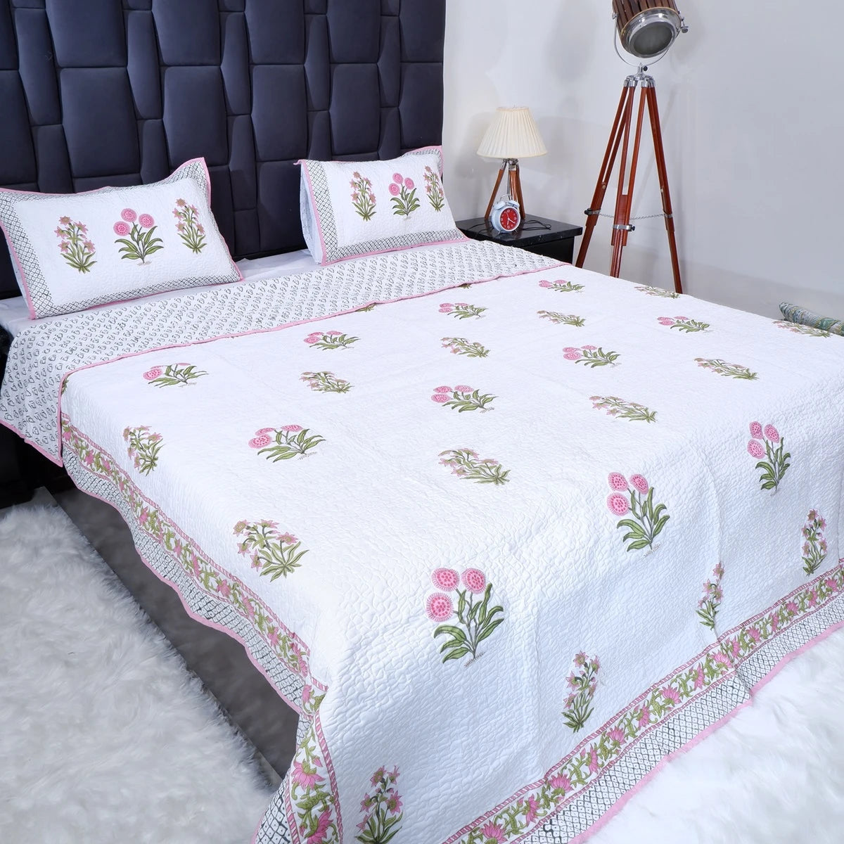 Hand block print cotton bedcover in white with floral designs and matching pillow shams