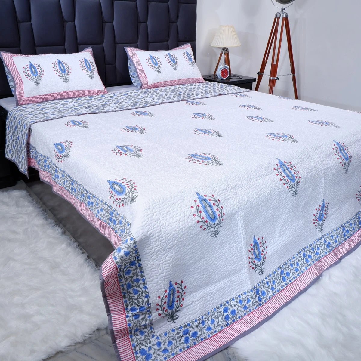 White hand block print cotton bedcover with floral patterns and matching pillow covers for elegant bedroom decor