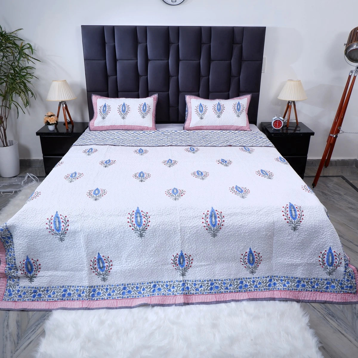 Hand block print cotton bedcover in white with floral patterns and coordinating pillow covers