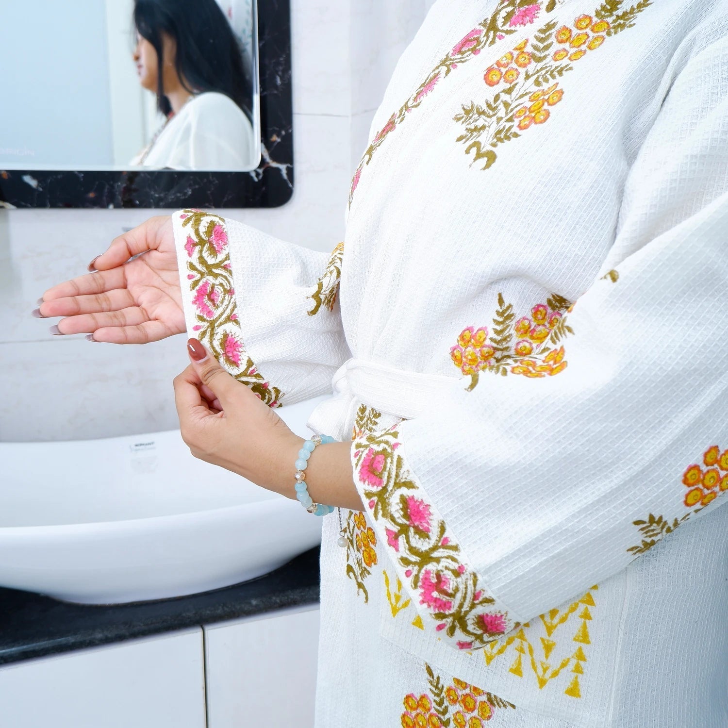 Hand block printed cotton bathrobe in white with colorful floral patterns and a belt