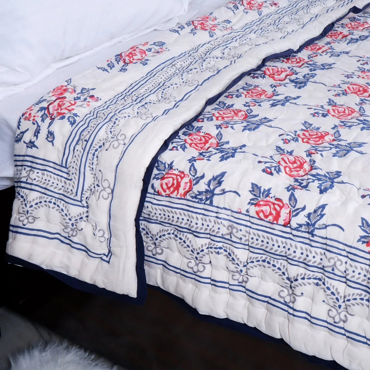 Handcrafted Jaipuri bedding online featuring floral patterns in blue and red hues for stylish bedrooms