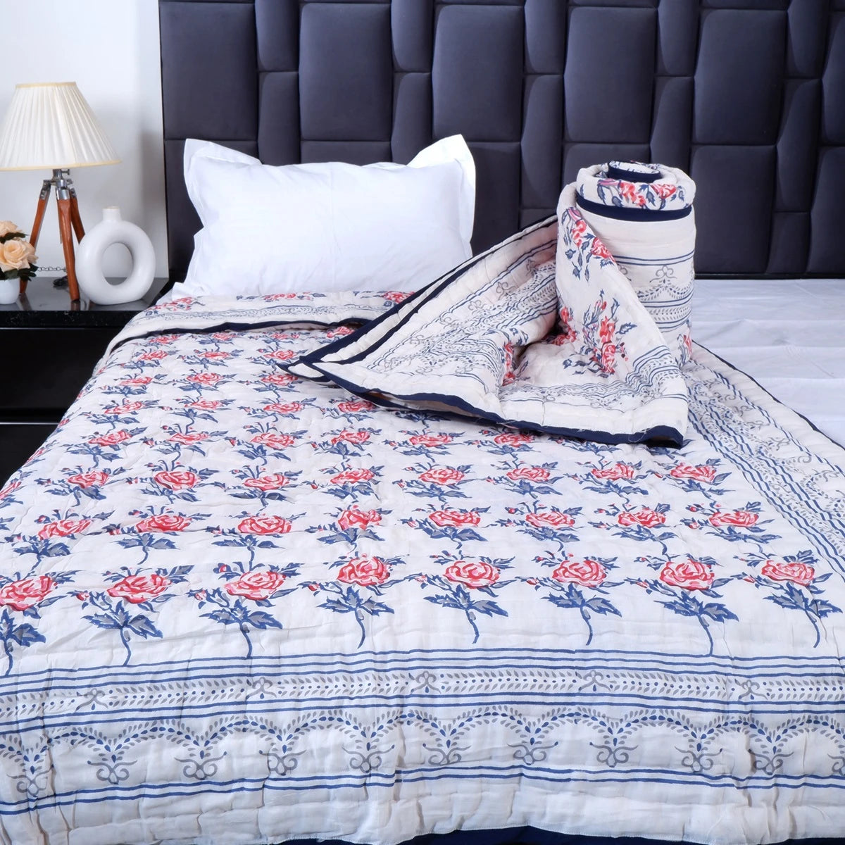 Handcrafted Jaipuri bedding online featuring floral patterns on a quilt in elegant colors