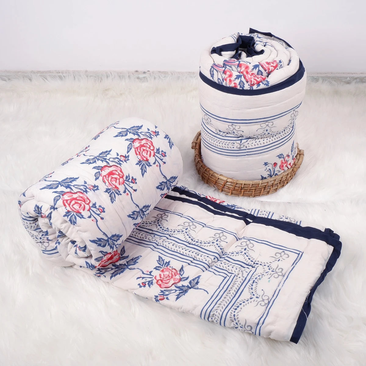 Handcrafted Jaipuri bedding online featuring floral design and vibrant colors in a rolled quilt