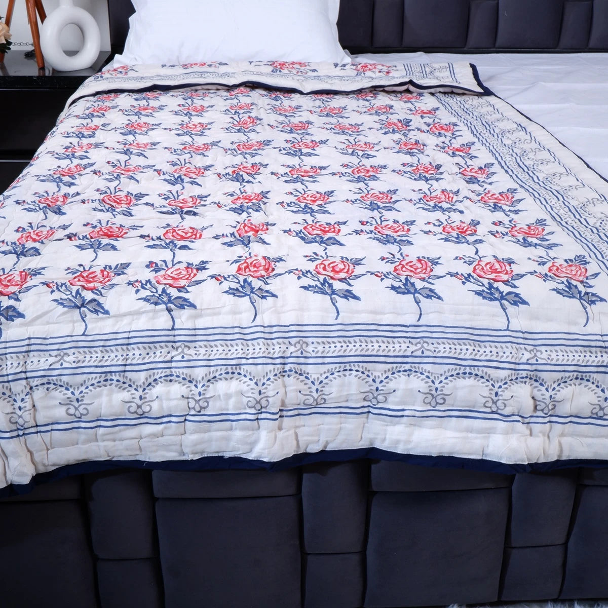 Handcrafted Jaipuri bedding online featuring intricate floral patterns in rose and blue on a soft quilt