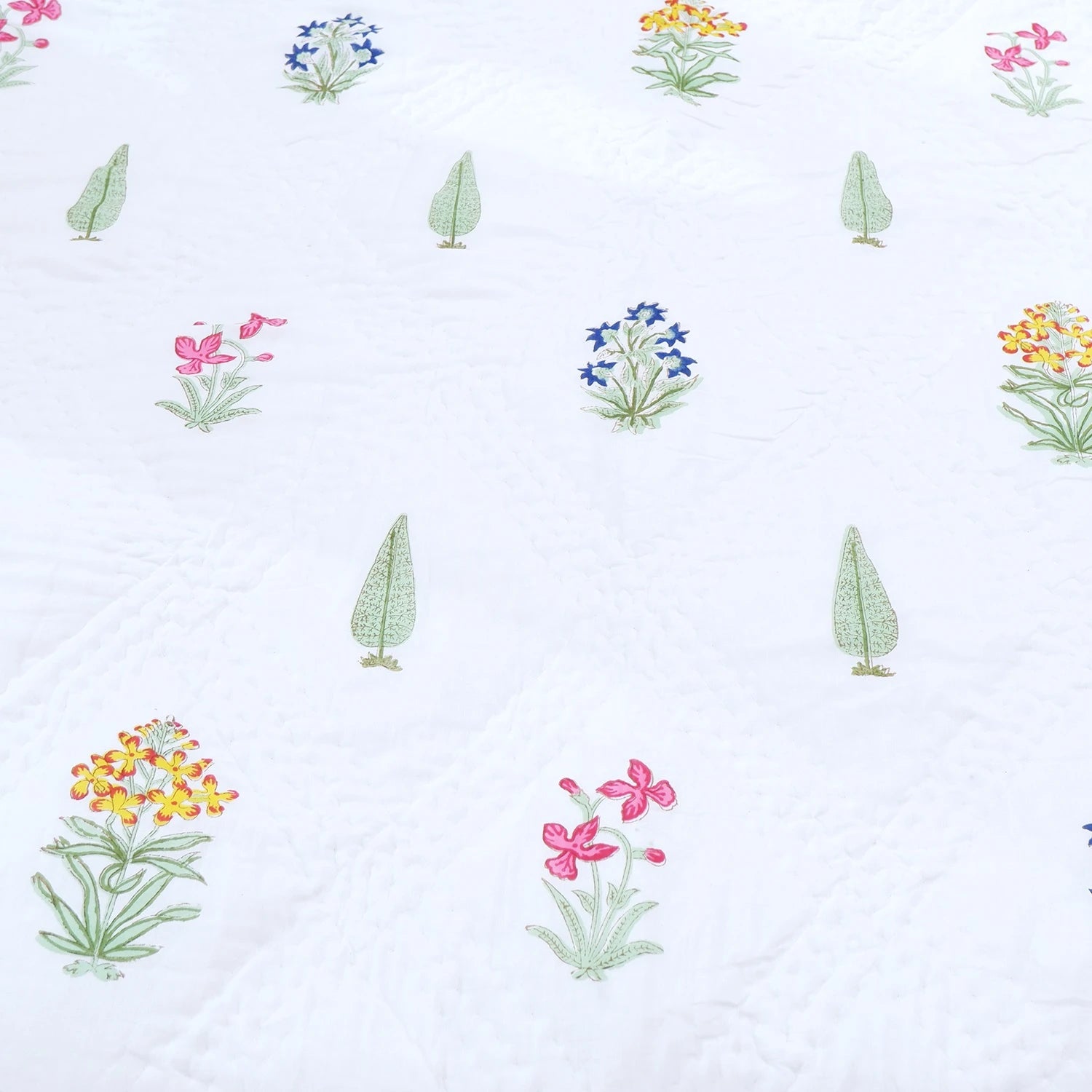 Jaipuri block print quilt set featuring vibrant floral designs on a white background