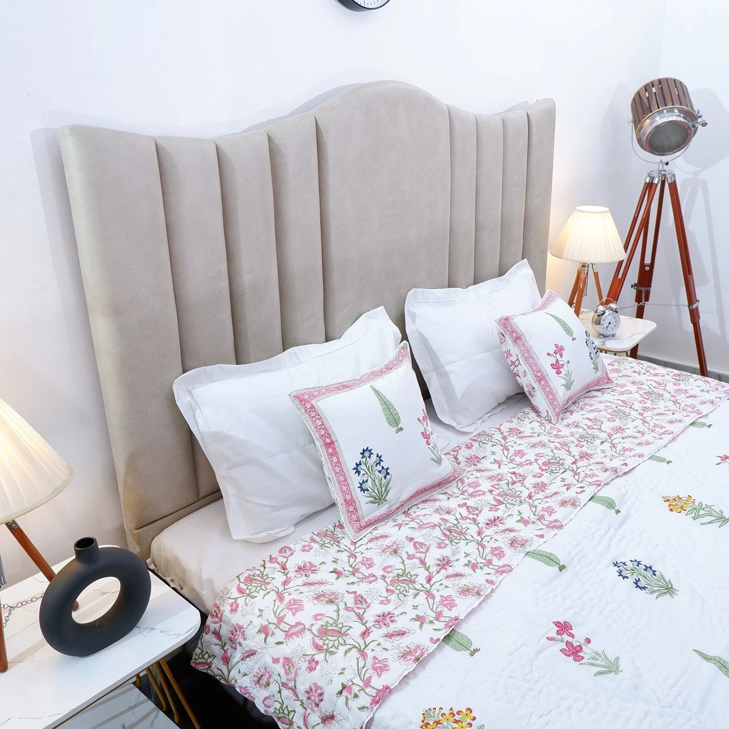 Jaipuri block print quilt set displayed beautifully on a styled bed with decorative pillows