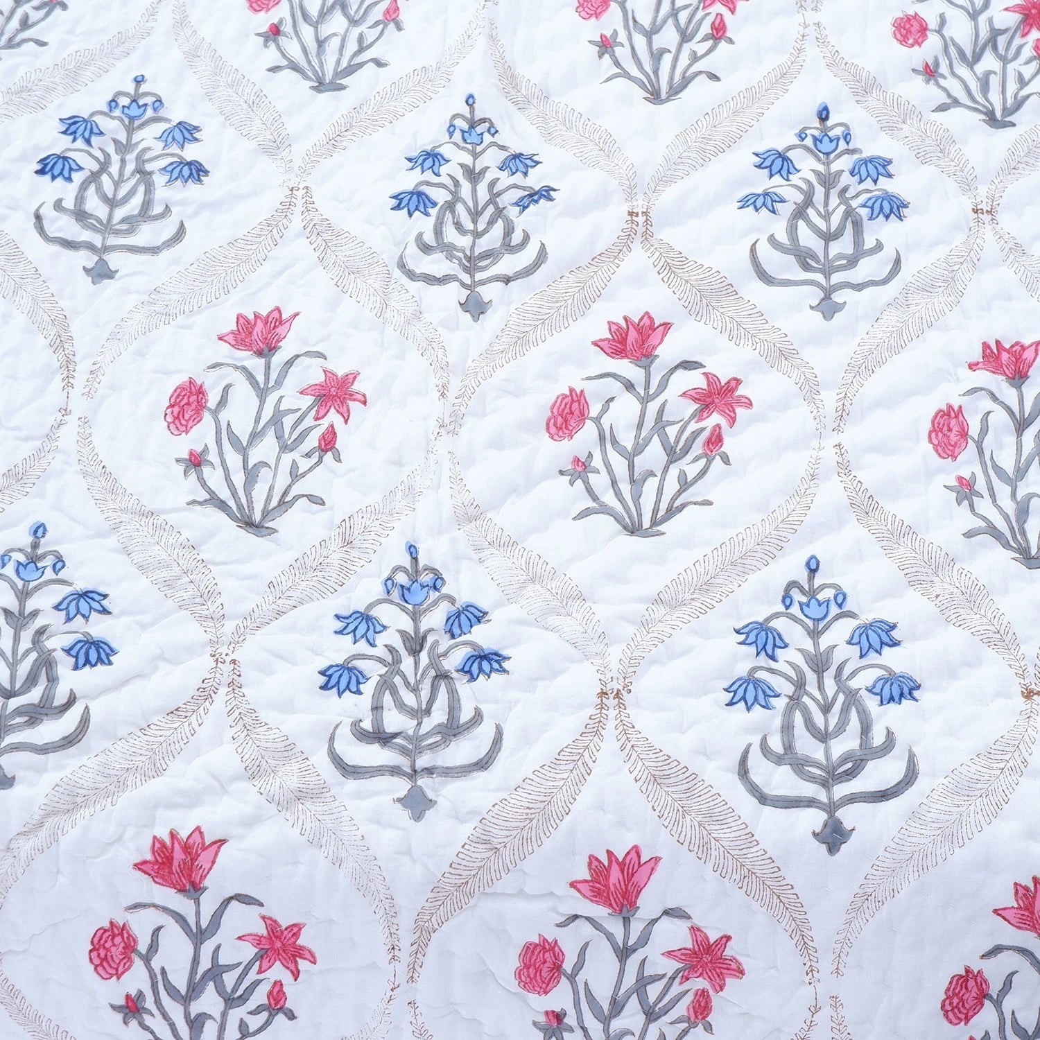 Jaipuri block print quilts featuring intricate floral designs in vibrant colors on a soft background