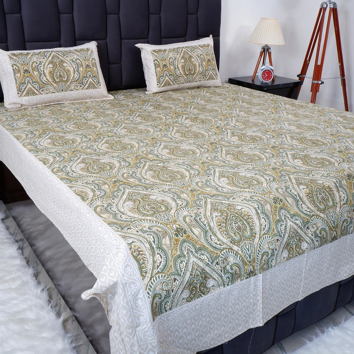 Jaipuri cotton bed sheet in green paisley pattern with matching pillow covers on a modern bed