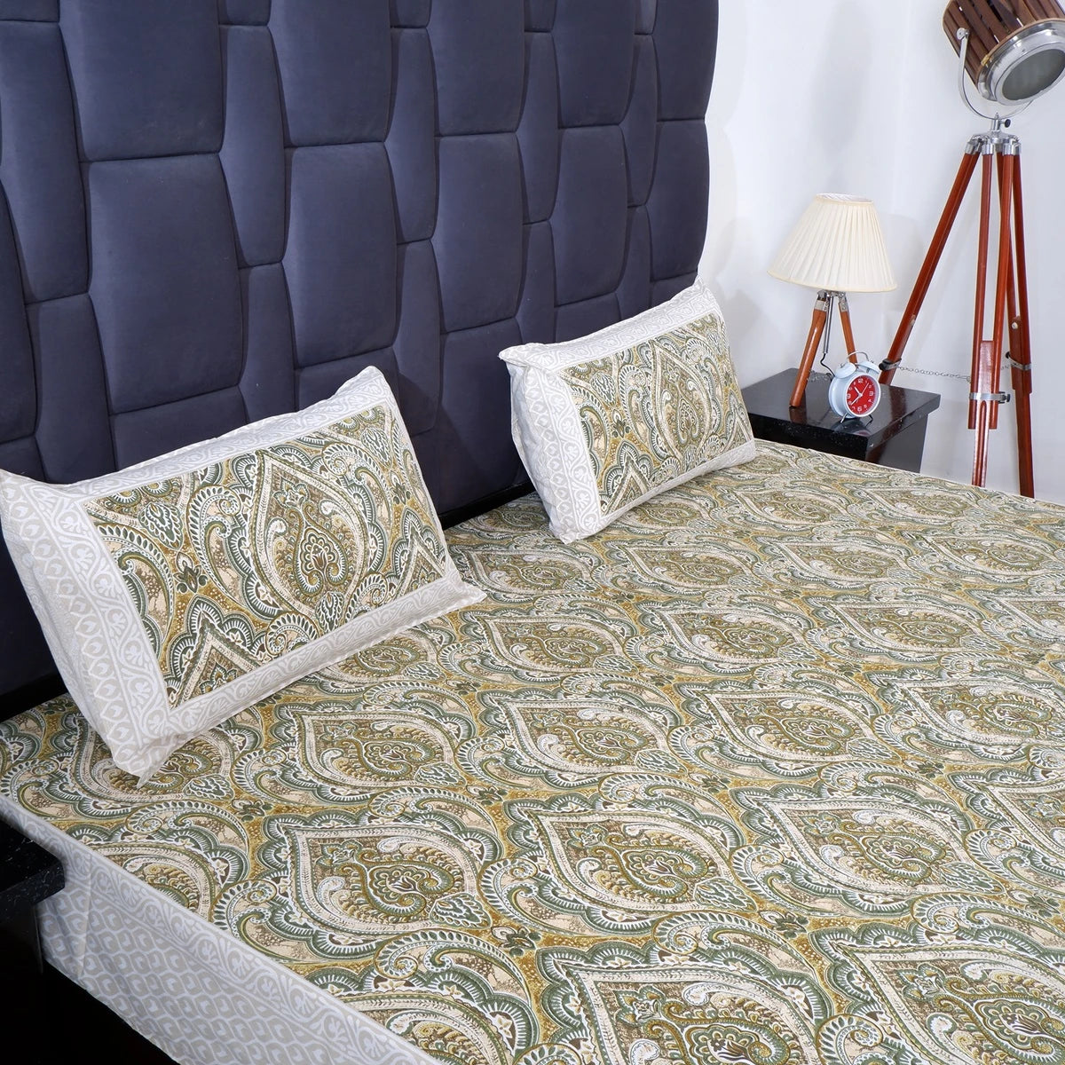 Jaipuri cotton bed sheet with elegant green paisley pattern and matching pillow covers on a bed