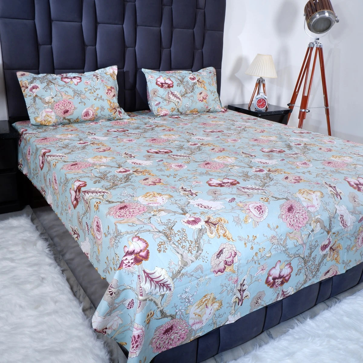 Jaipuri cotton bedsheet online featuring floral patterns in vibrant colors on a stylish bed