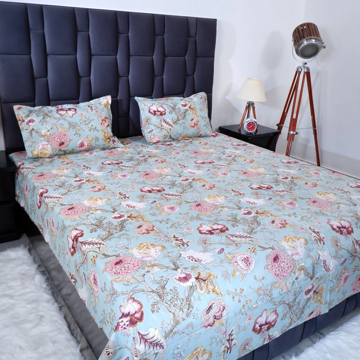 Jaipuri cotton bedsheet online featuring a floral pattern on a light blue background with matching pillow covers