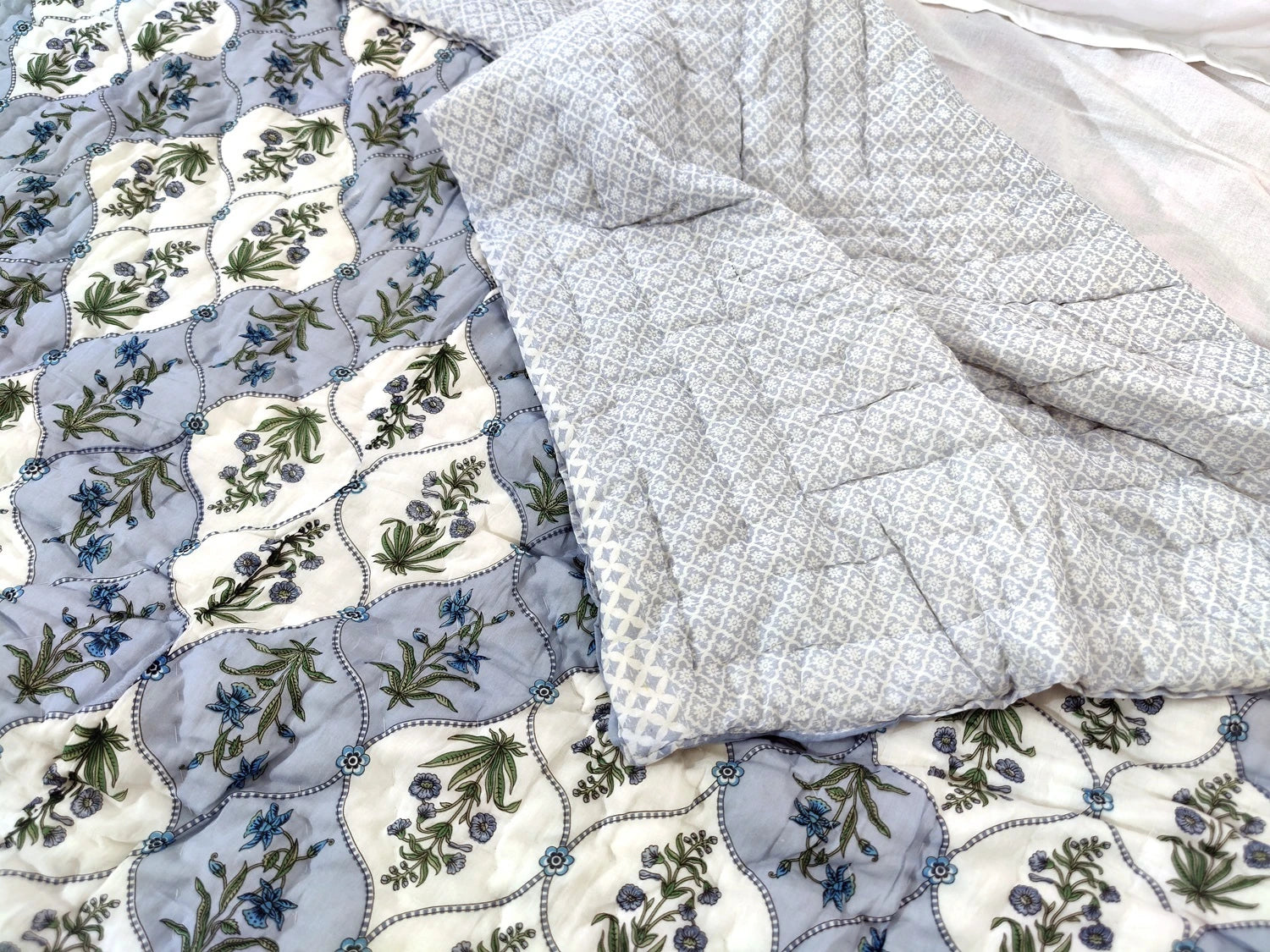 Jaipuri cotton quilt double bed featuring floral patterns and a soft, lightweight design