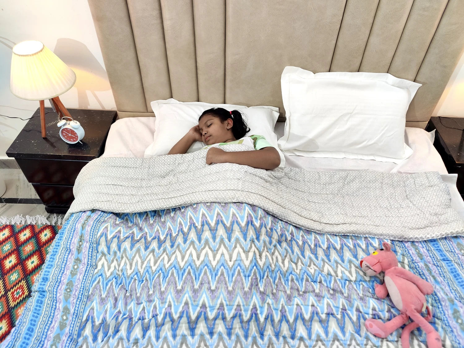 Jaipuri cotton quilt double bed in use, providing warmth to a sleeping child on a cozy bed
