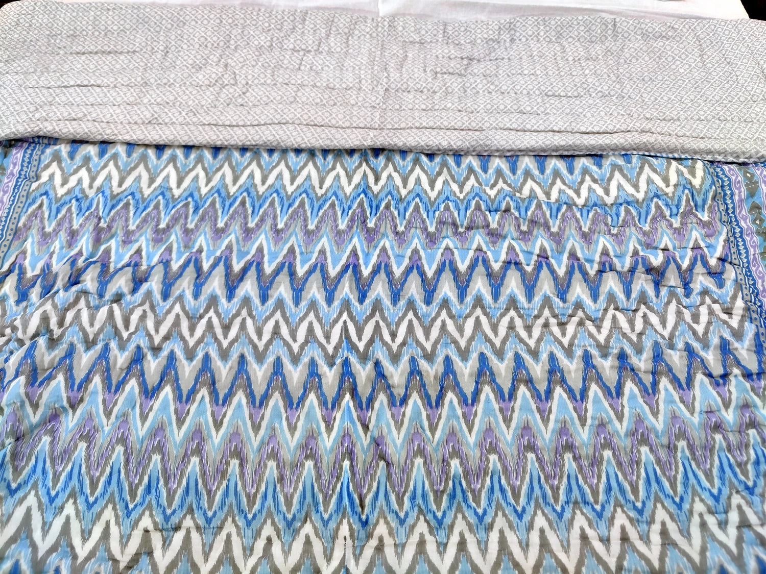 Jaipuri cotton quilt double bed with vibrant zigzag patterns in blue and gray tones