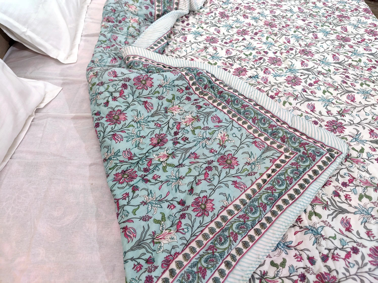 Jaipuri cotton quilt double bed featuring intricate floral patterns in soft pastel colors