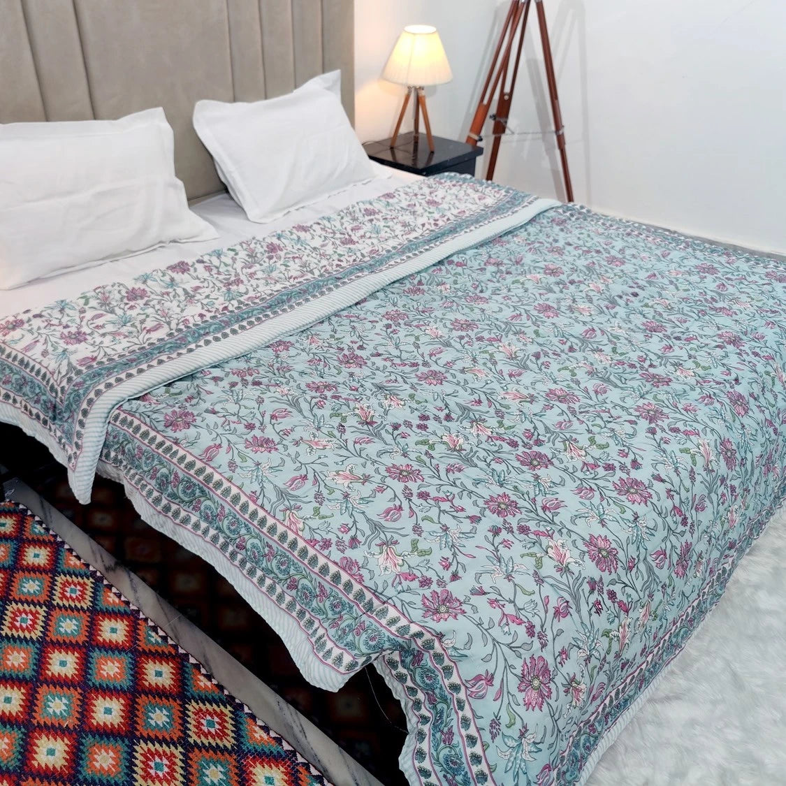 Jaipuri cotton quilt double bed in pastel floral design on a neatly made bed
