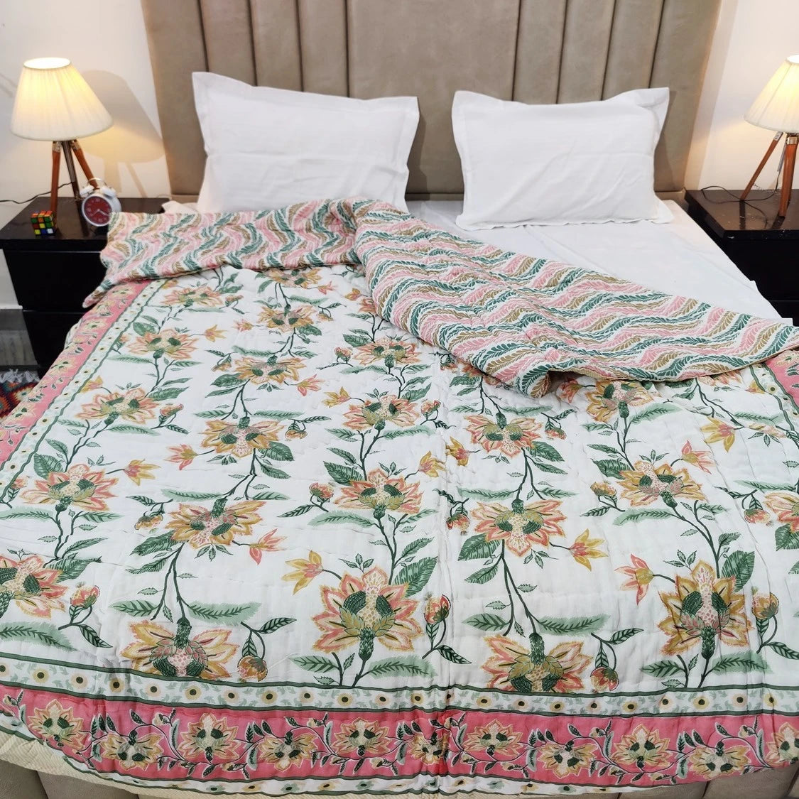 Jaipuri cotton quilt double bed with floral design laid on a neatly arranged bed