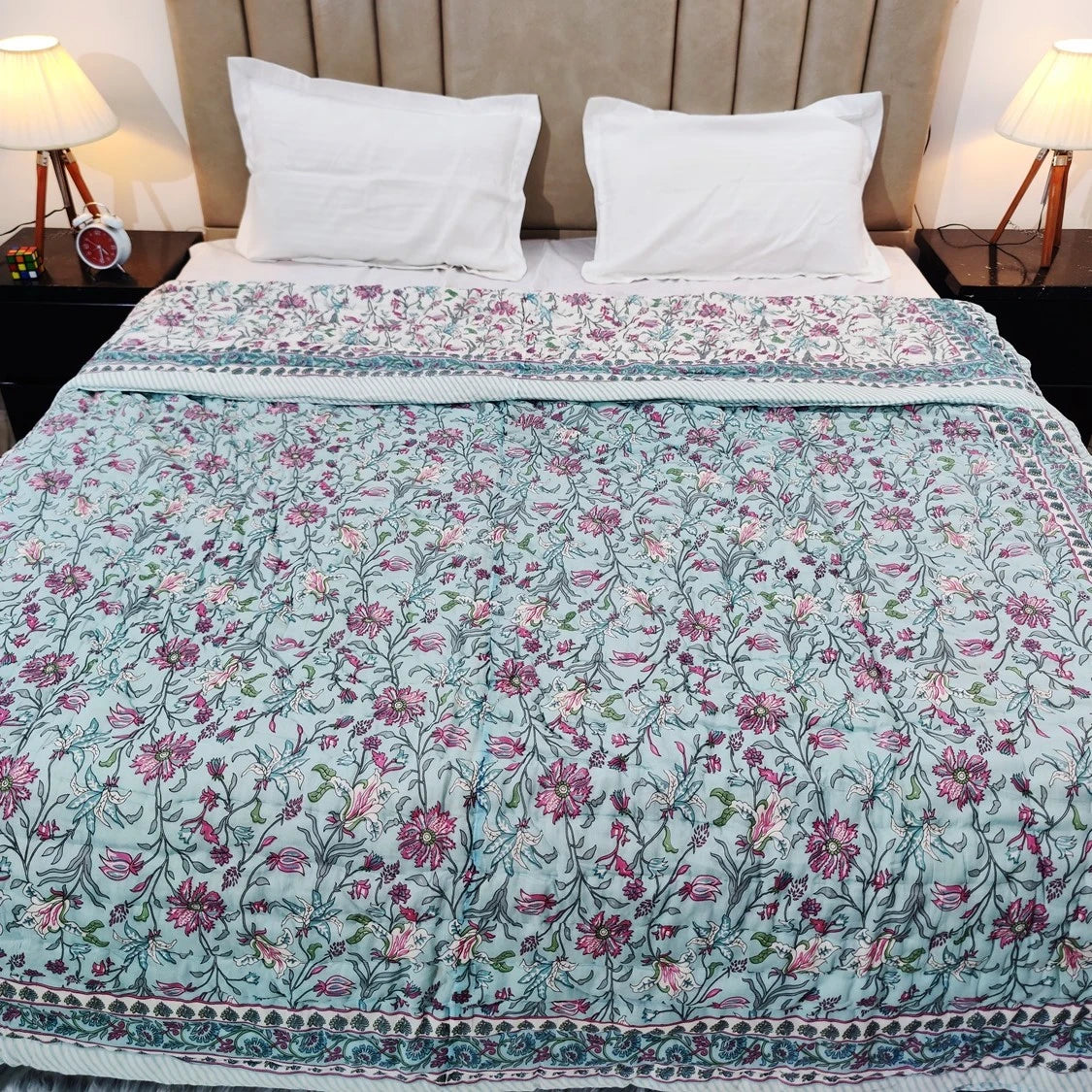 Jaipuri cotton quilt double bed with beautiful floral design and vibrant colors on a neatly made bed