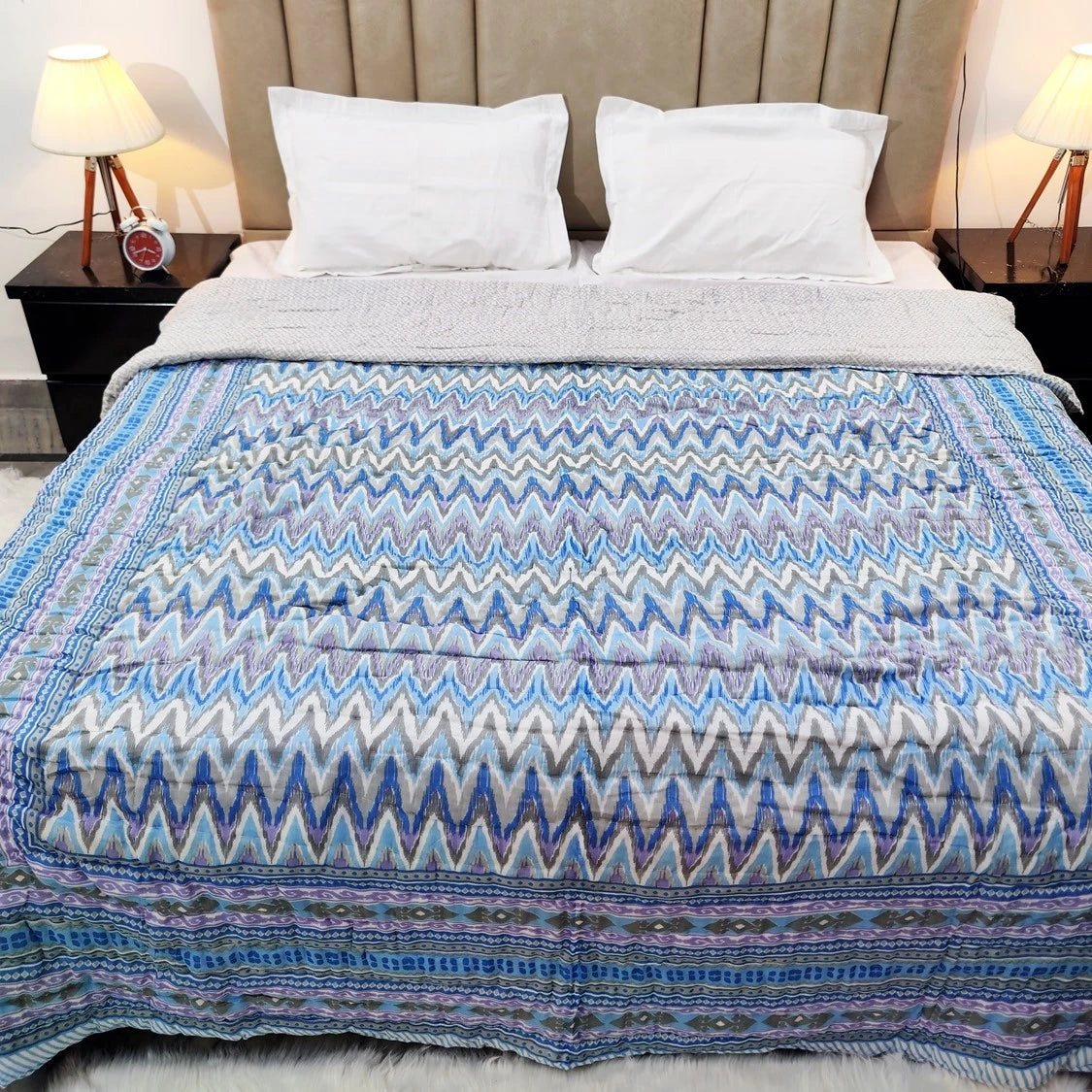 Jaipuri cotton quilt double bed in vibrant zigzag pattern on a neatly made bed