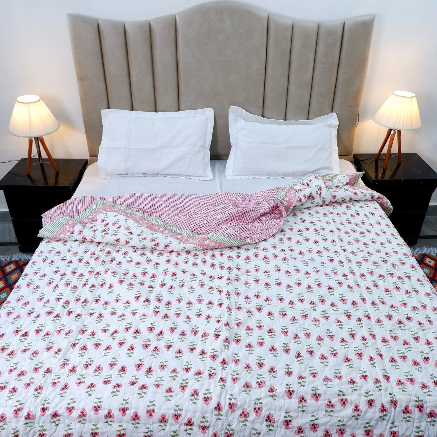 Jaipuri cotton quilt double bed with floral design draped over a neatly made bed