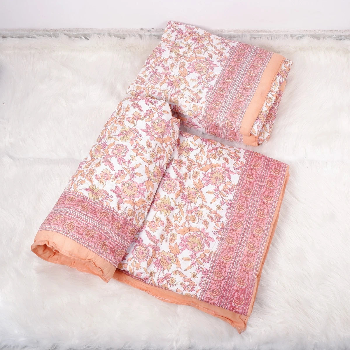 Jaipuri cotton quilt single bed in floral design with pink and orange accents, perfect for cozy bedrooms