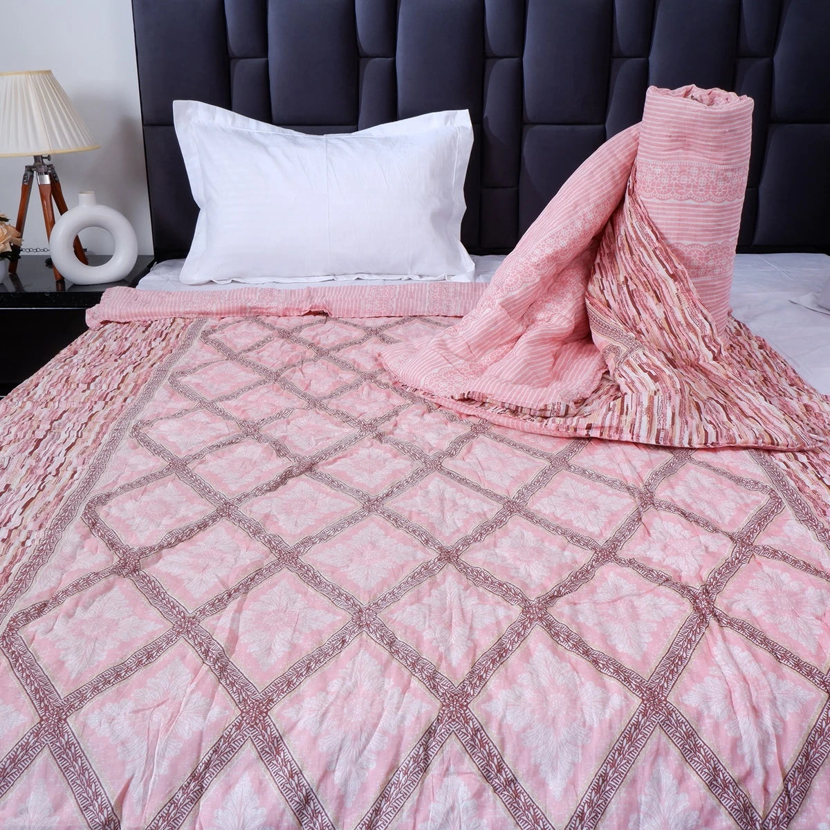 Jaipuri cotton quilt single bed in soft pink with intricate diamond pattern on a cozy bed setup