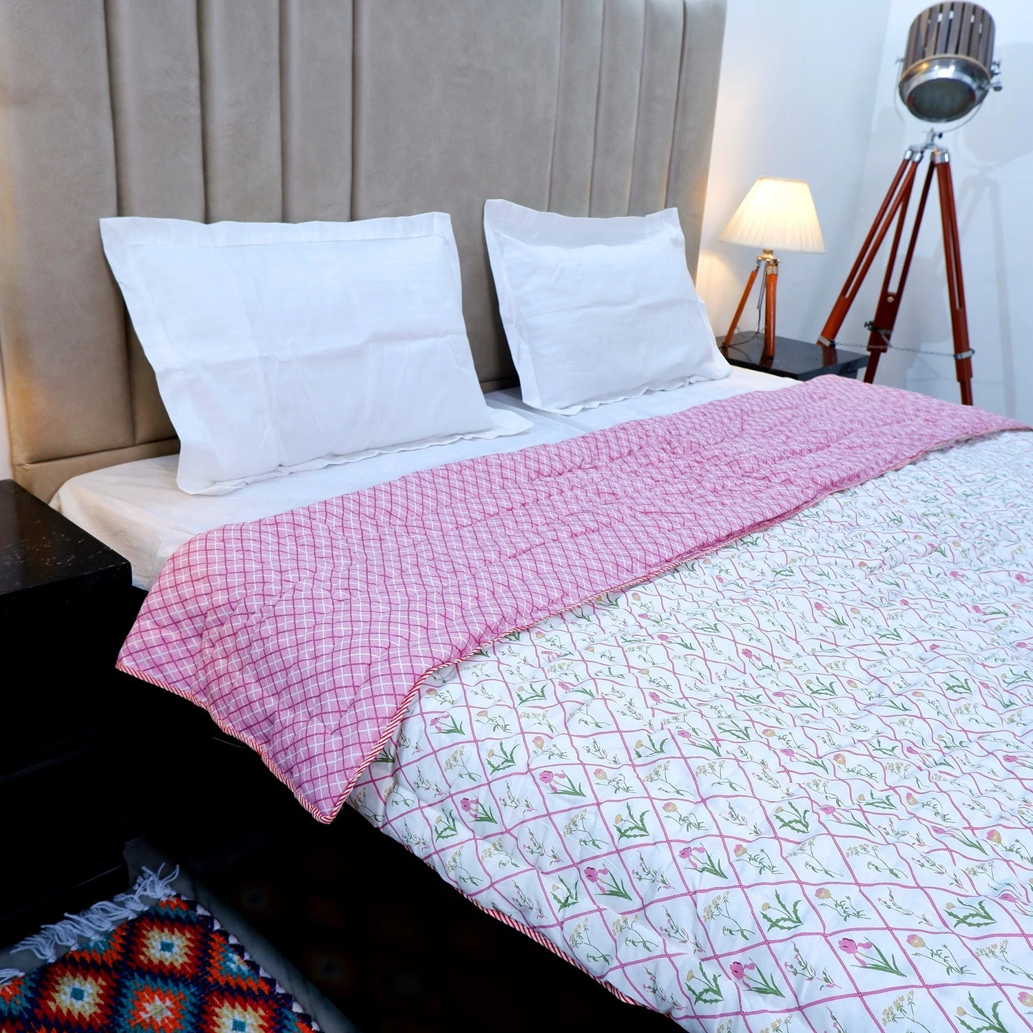 Jaipuri cotton quilts double bed in pink design placed on a stylish bed with white linens