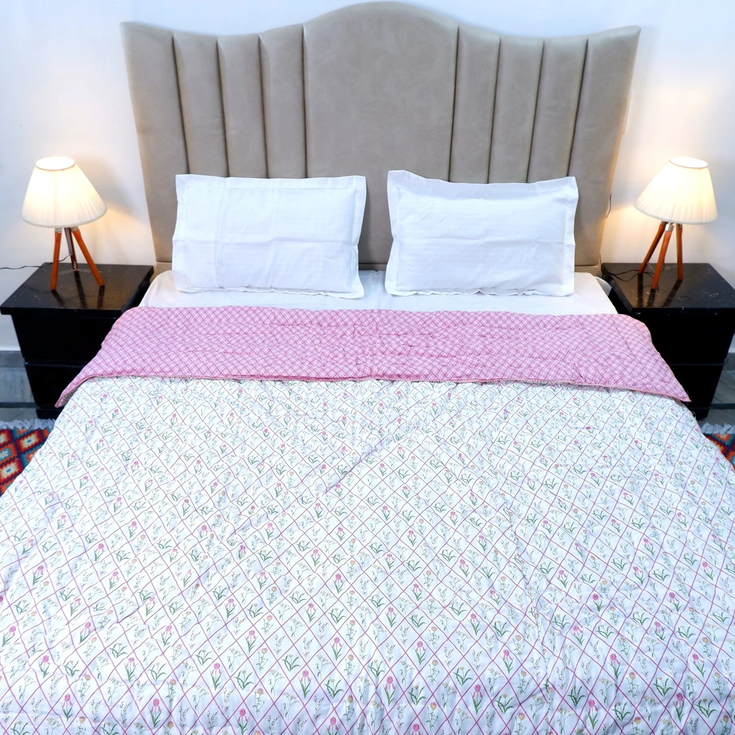 Jaipuri cotton quilts double bed with floral patterns and a pink border on a cozy bed setup