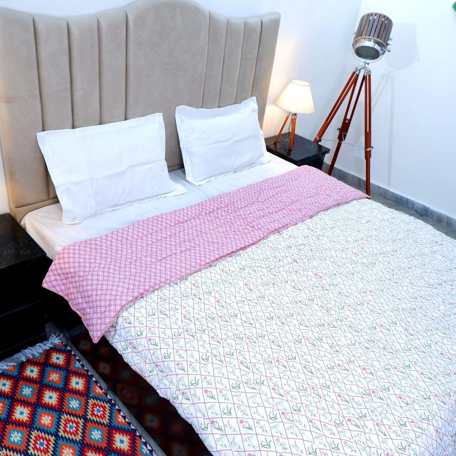 Jaipuri cotton quilts double bed with floral patterns and a pink accent on a cozy bed setup