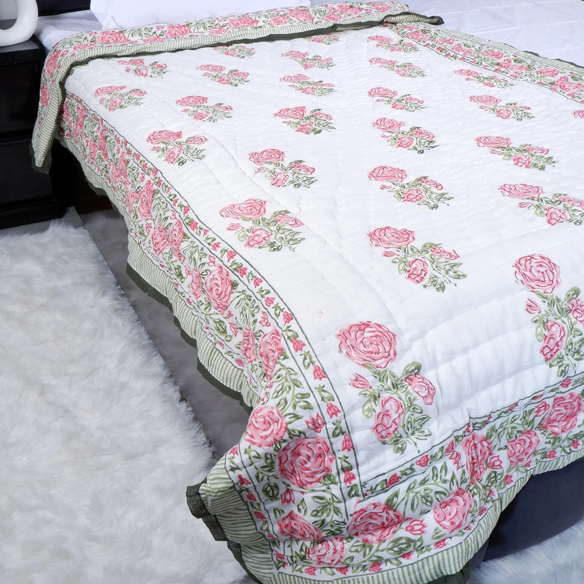 Jaipuri quilt single bed with floral design in pink and green colors for a cozy bedroom look