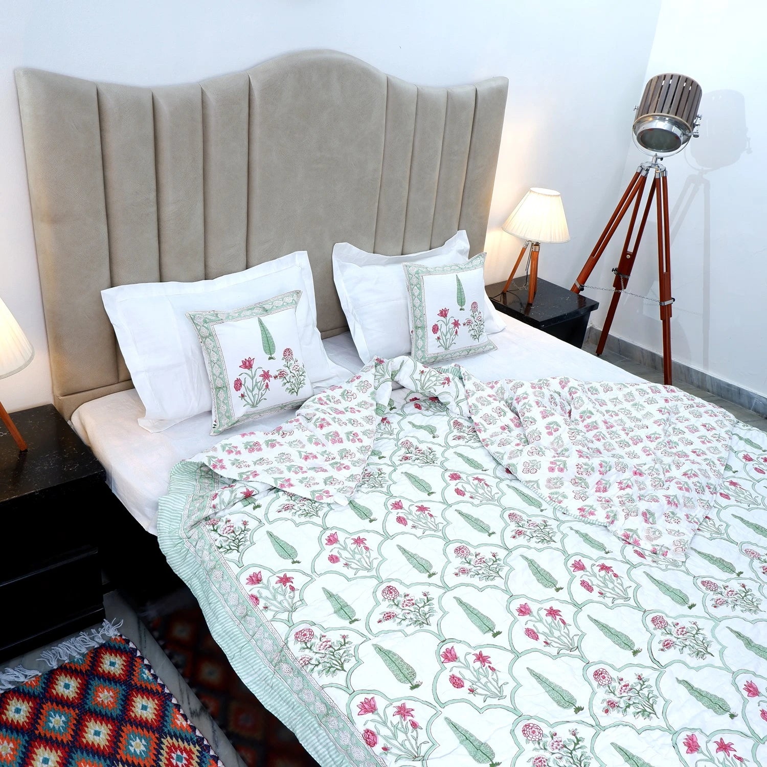 Elegant Jaipuri quilts double bed in floral design on a stylish bed with decorative pillows
