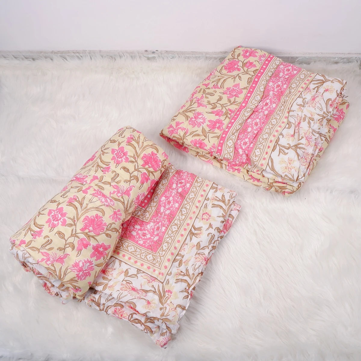 Beautiful Jaipuri quilts for single bed featuring floral patterns in pink and beige tones