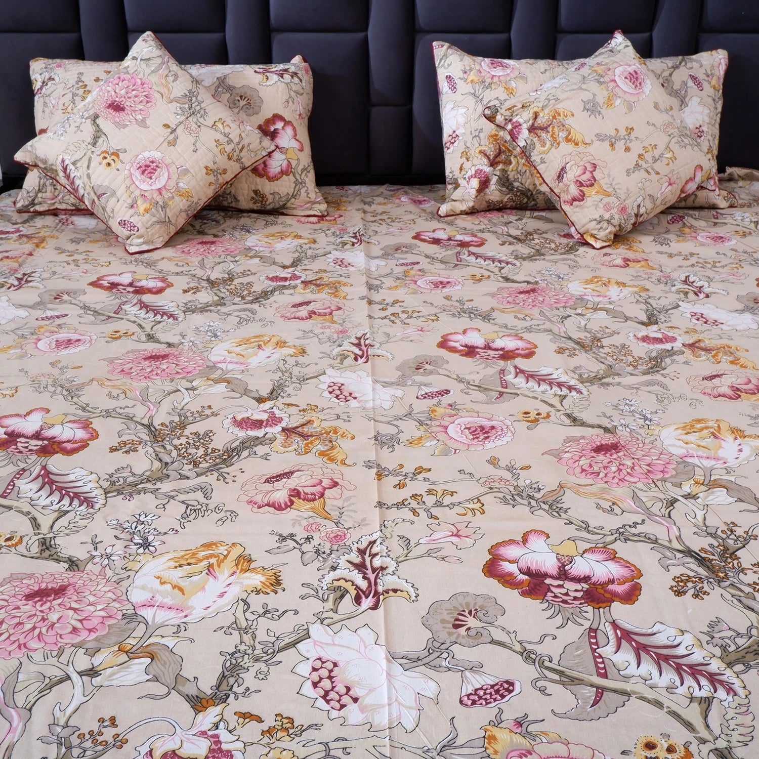 The Jaipuri pure cotton bed sheet with vibrant floral patterns and decorative cushions for elegant bedding