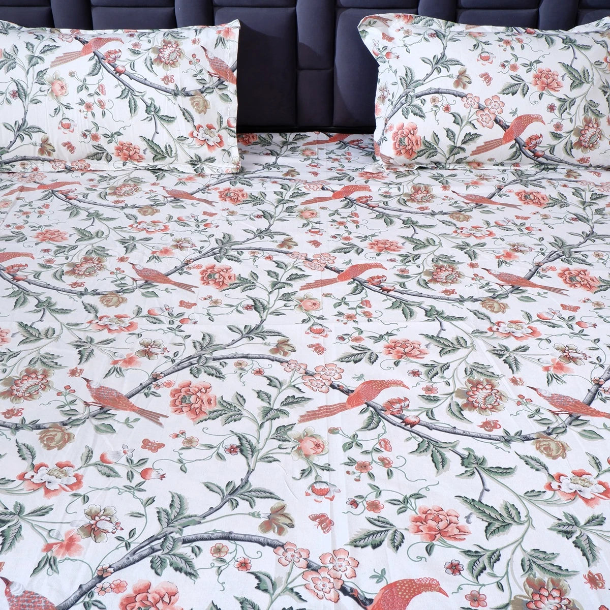 The Jaipuri pure cotton bed sheet with floral design and matching pillow covers on a stylish bed