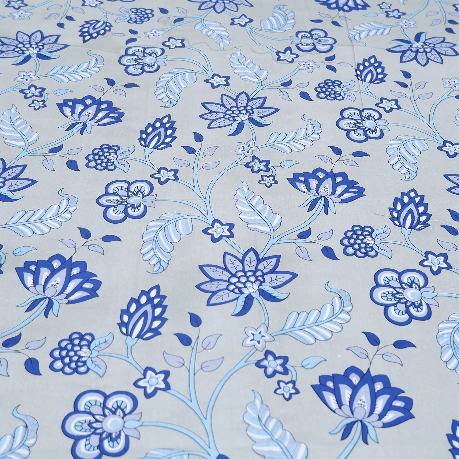 The Jaipuri pure cotton bed sheet with floral blue pattern on a light background