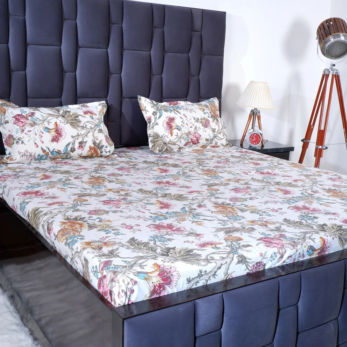 The Jaipuri pure cotton bed sheet with floral design on a neatly made bed