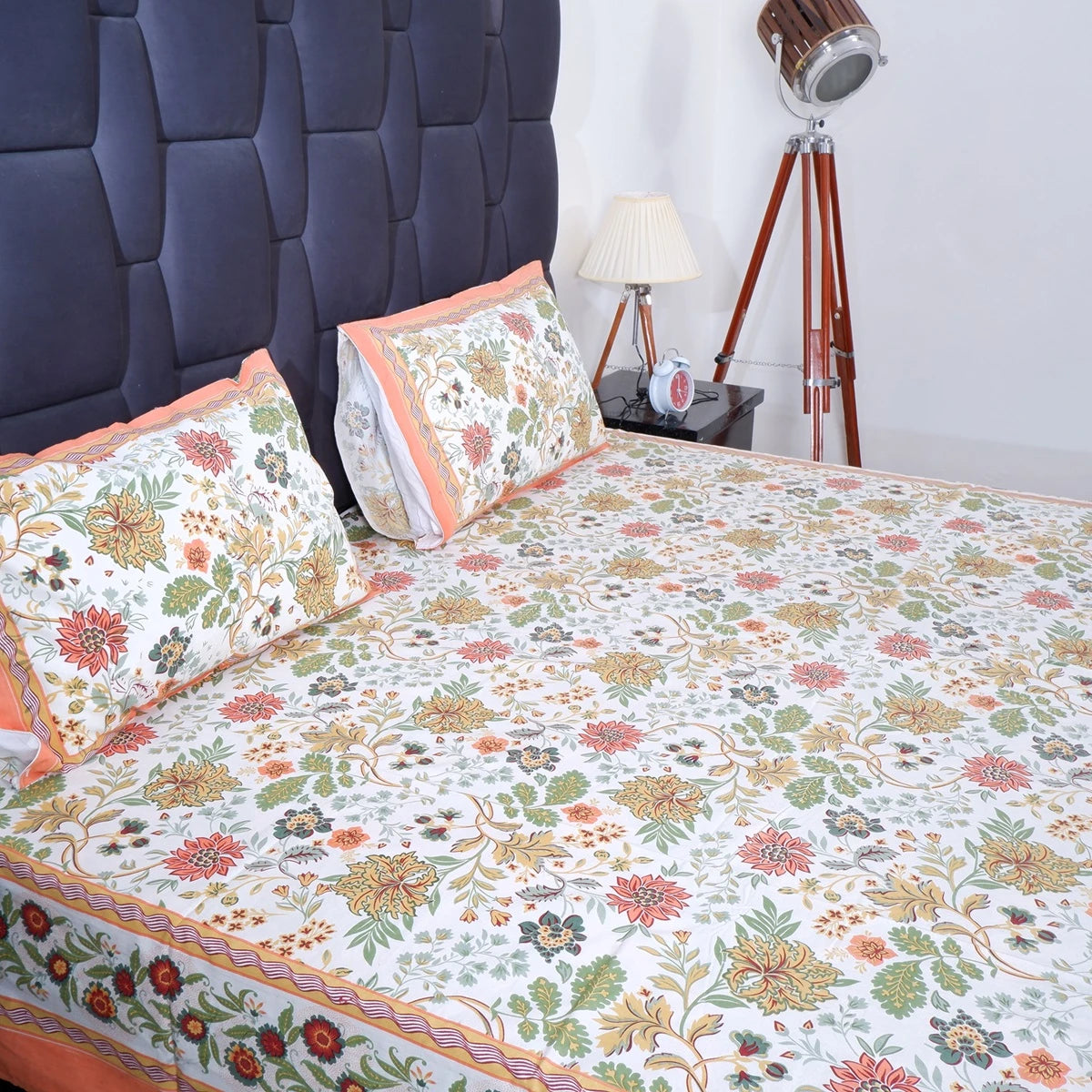 The Jaipuri pure cotton bed sheet with vibrant floral patterns and coordinating pillow covers for stylish bedding