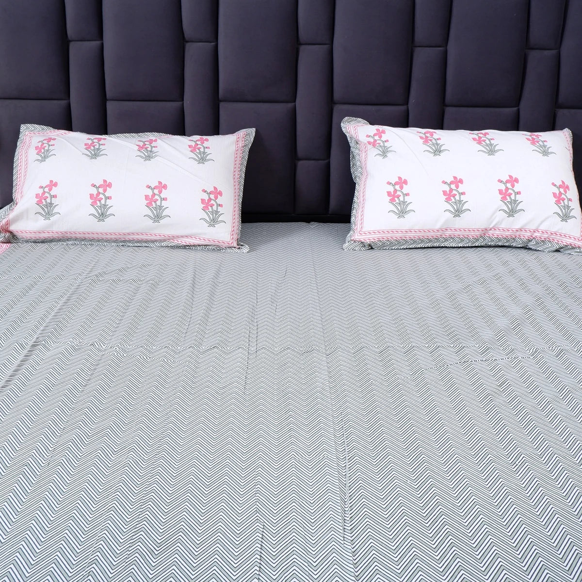 Pure cotton bed sheet Jaipur in grey herringbone pattern with floral pillow covers for a stylish bedroom